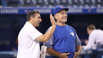 Manager John Gibbons of the Toronto Blue Jays shares a laugh with J.P. Ricciardi prior to a 2018 game between the Blue Jays and New York Mets at Rogers Centre. Ricciardi was named special advisor to Giants President Farhan Zaidi Monday. (Photo by Tom Szczerbowski/Getty Images)