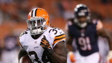 Aug 28, 2014; Cleveland, OH, USA; Cleveland Browns running back Isaiah Crowell (34) breaks away from Chicago Bears defensive end David Bass (91) for a touchdown during the fourth quarter at FirstEnergy Stadium. The Browns won 33-13. Mandatory Credit: Ron Schwane-USA TODAY Sports