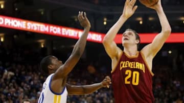 Jan 9, 2015; Oakland, CA, USA; Cleveland Cavaliers center Timofey Mozgov (20) attempts a shot over Golden State Warriors forward Harrison Barnes (40) in the second quarter at Oracle Arena. Mandatory Credit: Cary Edmondson-USA TODAY Sports