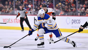 Nov 1, 2023; Philadelphia, Pennsylvania, USA; Buffalo Sabres defenseman Henri Jokiharju (10) reaches for the puck against the Philadelphia Flyers in the second period at Wells Fargo Center. Mandatory Credit: Kyle Ross-USA TODAY Sports
