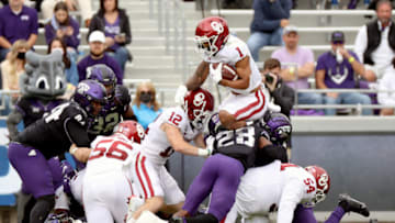 Oct 24, 2020; Fort Worth, Texas, USA; Oklahoma Sooners running back Seth McGowan (1) jumps over TCU Horned Frogs safety Nook Bradford (28) during the second half at Amon G. Carter Stadium. Mandatory Credit: Kevin Jairaj-USA TODAY Sports