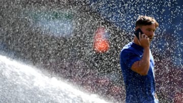 HUDDERSFIELD, ENGLAND - AUGUST 11: Danny Drinkwater of Chelsea speaks on his phone during a pitch inspection prior to the Premier League match between Huddersfield Town and Chelsea FC at John Smith's Stadium on August 11, 2018 in Huddersfield, United Kingdom. (Photo by Shaun Botterill/Getty Images)