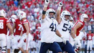 MADISON, WI - SEPTEMBER 15: Adam Pulsipher #41 and Merrill Taliauli #54 of the BYU Cougars celebrate after a missed field goal in the fourth quarter of the game by the Wisconsin Badgers at Camp Randall Stadium on September 15, 2018 in Madison, Wisconsin. BYU won 24-21. (Photo by Joe Robbins/Getty Images)