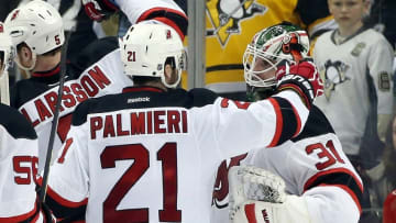 Mar 24, 2016; Pittsburgh, PA, USA; New Jersey Devils right wing Kyle Palmieri (21) and goalie Scott Wedgewood (31) celebrate after defeating the Pittsburgh Penguins 3-0 at the CONSOL Energy Center. Mandatory Credit: Charles LeClaire-USA TODAY Sports