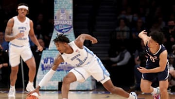 Mar 10, 2022; Brooklyn, NY, USA; North Carolina Tar Heels guard Leaky Black (1) grabs a loose ball against Virginia Cavaliers guard Kihei Clark (0) during the first half at Barclays Center. Mandatory Credit: Brad Penner-USA TODAY Sports