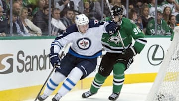 Jan 7, 2016; Dallas, TX, USA; Winnipeg Jets defenseman Jacob Trouba (8) keeps the puck away from Dallas Stars center Jason Spezza (90) during the second period at the American Airlines Center. Mandatory Credit: Jerome Miron-USA TODAY Sports