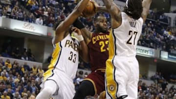 Feb 1, 2016; Indianapolis, IN, USA; Cleveland Cavaliers forward LeBron James (23) attempts to pass the ball between Indiana Pacers centers Myles Turner (33) and Jordan Hill (27) at Bankers Life Fieldhouse. The Cavaliers won 111-106 in overtime. Mandatory Credit: Brian Spurlock-USA TODAY Sports