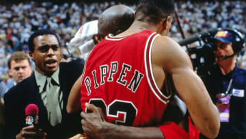 SALT LAKE CITY, UT - JUNE 11: Michael Jordan #23 hugs teammate Scottie Pippen #33 of the Chicago Bulls following Game Five of the 1997 NBA Finals played against the Utah Jazz on June 11, 1997 at the Delta Center in Salt Lake City, Utah. The Chicago Bulls defeated the Utah Jazz 90-88. Ahmad Rashad tries to get an interview for NBC. NOTE TO USER: User expressly acknowledges and agrees that, by downloading and or using this photograph, User is consenting to the terms and conditions of the Getty Images License Agreement. Mandatory Copyright Notice: Copyright 1997 NBAE (Photo by Nathaniel S. Butler/NBAE via Getty Images)
