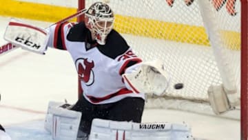 Apr 10, 2014; Ottawa, Ontario, CAN; New Jersey Devils goalie Cory Schneider (35) deflects a shot in the third period against the Ottawa Senators at the Canadian Tire Centre. The Senators defeated the Devils 2-1 in a shootout. Mandatory Credit: Marc DesRosiers-USA TODAY Sports