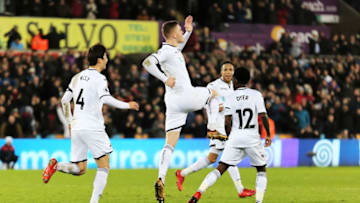 SWANSEA, WALES - JANUARY 22: Alfie Mawson of Swansea City (C) celebrates his goal during the Premier League match between Swansea City and Liverpool at The Liberty Stadium on January 22, 2018 in Swansea, Wales. (Photo by Athena Pictures/Getty Images)