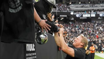 Sep 26, 2021; Paradise, Nevada, USA; Las Vegas Raiders coach Jon Gruden (right) celebrates with Raiders fan Mark Acasio aka Gorilla RIlla after the game against the Miami Dolphins at Allegiant Stadium.The Raiders defeated the Dolphins 31-28 in overtime. Mandatory Credit: Kirby Lee-USA TODAY Sports