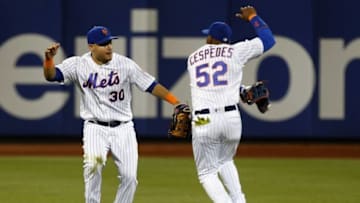 Jun 21, 2016; New York City, NY, USA; New York Mets left fielder Michael Conforto (30) and center fielder Yoenis Cespedes (52) react after defeating the Kansas City Royals 2-1 at Citi Field. Mandatory Credit: Noah K. Murray-USA TODAY Sports