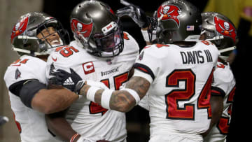 NEW ORLEANS, LOUISIANA - JANUARY 17: Devin White #45 of the Tampa Bay Buccaneers celebrates with his teammates after intercepting a pass thrown by Drew Brees #9 of the New Orleans Saints during the fourth quarter in the NFC Divisional Playoff game at Mercedes Benz Superdome on January 17, 2021 in New Orleans, Louisiana. (Photo by Chris Graythen/Getty Images)