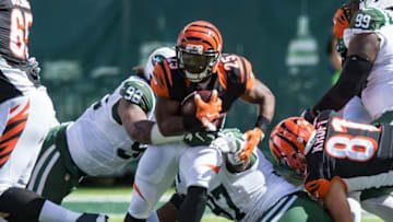 Sep 11, 2016; East Rutherford, NJ, USA; Cincinnati Bengals running back Giovani Bernard (25) runs through New York Jets defensive tackle Leonard Williams (92) and defensive tackle Lawrence Thomas (97) in the second half at MetLife Stadium. The Bengals defeated the Jets 23-22. Mandatory Credit: William Hauser-USA TODAY Sports