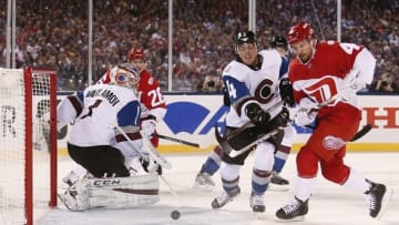 Feb 27, 2016; Denver, CO, USA; Colorado Avalanche defenseman Tyson Barrie (4) battles for the puck with Detroit Red Wings center Luke Glendening (41) in front of Avalanche goalie Semyon Varlamov (1) in the first period of the Stadium Series hockey game at Coors Field. Mandatory Credit: Isaiah J. Downing-USA TODAY Sports