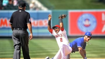 August 4, 2013; Anaheim, CA, USA; Los Angeles Angels shortstop Erick Aybar (2) reacts to second base umpire Brian Knight after Toronto Blue Jays third baseman Brett Lawrie (13) is called safe in the ninth inning at Angel Stadium of Anaheim. Mandatory Credit: Gary A. Vasquez-USA TODAY Sports