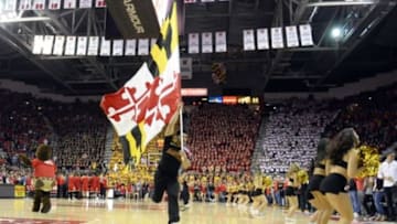 Feb 13, 2016; College Park, MD, USA; Maryland Terrapins flag bearer runs off the court before the during the first half at Xfinity Center. Mandatory Credit: Tommy Gilligan-USA TODAY Sports