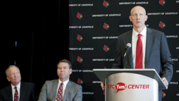 LOUISVILLE, KY - MARCH 28: Chris Mack speaks after being introduced as new men's basketball coach of the University of Louisville Cardinals as interim president Gregory Postel and athletic director Vince Tyra look on during a press conference at KFC YUM! Center on March 28, 2018 in Louisville, Kentucky. (Photo by Joe Robbins/Getty Images)