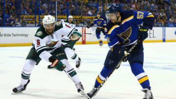 ST. LOUIS, MO - APRIL 19: David Perron #57 of the St. Louis Blues controls the puck against Marco Scandella #6 of the Minnesota Wild in Game Four of the Western Conference First Round during the 2017 NHL Stanley Cup Playoffs at the Scottrade Center on April 19, 2017 in St. Louis, Missouri. (Photo by Dilip Vishwanat/Getty Images)