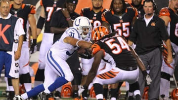 Aug 29, 2013; Cincinnati, OH, USA; Indianapolis Colts running back Donald Brown (31) stiff arms Cincinnati Bengals linebacker Mario Harvey (54) at Paul Brown Stadium. Mandatory Credit: Brian Spurlock-USA TODAY Sports