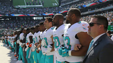 EAST RUTHERFORD, NJ - SEPTEMBER 24: Members of the Miami Dolphins lock arms for the National Anthem before the game against the New York Jets on September 24, 2017 at MetLife Stadium in East Rutherford, New Jersey. The Jets defeated the Dolphins 20-6. (Photo by Al Pereira/Getty Images)