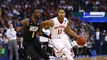 Mar 20, 2016; Oklahoma City, OK, USA; Oklahoma Sooners guard Isaiah Cousins (11) drives against Virginia Commonwealth Rams guard JeQuan Lewis (1) in the second half during the second round of the 2016 NCAA Tournament at Chesapeake Energy Arena. Mandatory Credit: Kevin Jairaj-USA TODAY Sports