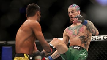 LAS VEGAS, NEVADA - DECEMBER 11: Sean O'Malley (R) kicks Raulian Paiva of Brazil in their bantamweight fight during the UFC 269 event at T-Mobile Arena on December 11, 2021 in Las Vegas, Nevada. (Photo by Carmen Mandato/Getty Images)