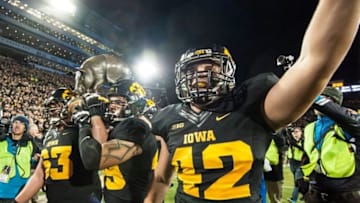 Nov 14, 2015; Iowa City, IA, USA; The Iowa Hawkeyes grasp the Floyd of Rosedale trophy after the game against the Minnesota Golden Gophers at Kinnick Stadium. Iowa won 40-35. Mandatory Credit: Jeffrey Becker-USA TODAY Sports