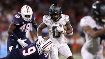 TUCSON, ARIZONA - OCTOBER 08: unning back Bucky Irving #0 of the Oregon Ducks rushes the football against safety Gunner Maldonado #9 of the Arizona Wildcats during the second half of the NCAAF game at Arizona Stadium on October 08, 2022 in Tucson, Arizona. (Photo by Christian Petersen/Getty Images)