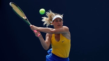 Mar 22, 2022; Miami Gardens, FL, USA; Marta Kostyuk of Ukraine hits a backhand against Alison van Uytvanck of Belgium (not pictured) in a first round women's singles match in the Miami Open at Hard Rock Stadium. Mandatory Credit: Geoff Burke-USA TODAY Sports