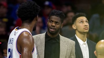 Dec 14, 2016; Philadelphia, PA, USA; Philadelphia 76ers center Joel Embiid (21) and forward Nerlens Noel (M) and forward Ben Simmons (R) during a timeout in the second half against the Toronto Raptors at Wells Fargo Center. The Toronto Raptors won 123.114. Mandatory Credit: Bill Streicher-USA TODAY Sports