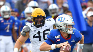 LAWRENCE, KANSAS - SEPTEMBER 21: Carter Stanley #9 of the Kansas Jayhawks scrambles out of the pocket as he looks for an open receiver against the West Virginia Mountaineers second quarter at Memorial Stadium on September 21, 2019 in Lawrence, Kansas. (Photo by Ed Zurga/Getty Images)