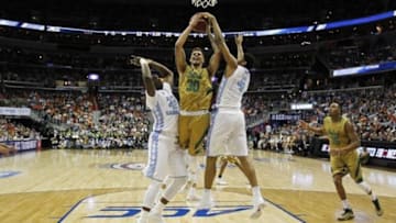Mar 11, 2016; Washington, DC, USA; Notre Dame Fighting Irish forward Zach Auguste (30) has his shot blocked by North Carolina Tar Heels forward Isaiah Hicks (4) as Tar Heels forward Joel James (42) defends in the first half during the semi-finals of the ACC Conference tournament at Verizon Center. The Tar Heels won 78-47. Mandatory Credit: Geoff Burke-USA TODAY Sports