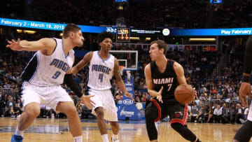 Feb 25, 2015; Orlando, FL, USA; Miami Heat guard Goran Dragic (7) drives to the basket as Orlando Magic guard Elfrid Payton (4) and center Nikola Vucevic (9) defend during the second quarter at Amway Center. Mandatory Credit: Kim Klement-USA TODAY Sports