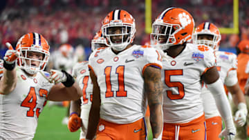 GLENDALE, ARIZONA - DECEMBER 28: Isaiah Simmons #11 of the Clemson Tigers is congratulated by his teammates after an interception against the Ohio State Buckeyes in the second half during the College Football Playoff Semifinal at the PlayStation Fiesta Bowl at State Farm Stadium on December 28, 2019 in Glendale, Arizona. (Photo by Norm Hall/Getty Images)