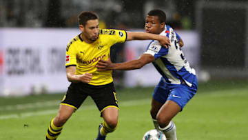 DORTMUND, GERMANY - JUNE 06: Raphael Guerreiro of Borussia Dortmund battles for the ball with Daishawn Redan of Hertha BSC during the Bundesliga match between Borussia Dortmund and Hertha BSC at Signal Iduna Park on June 06, 2020 in Dortmund, Germany. (Photo by Lars Baron/Getty Images)