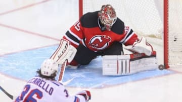 Feb 2, 2016; Newark, NJ, USA; New Jersey Devils goalie Cory Schneider (35) makes a save on New York Rangers right wing Mats Zuccarello (36) during the third period at Prudential Center. The Devils defeated the Rangers 3-2. Mandatory Credit: Ed Mulholland-USA TODAY Sports