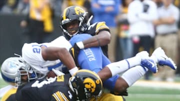 IOWA CITY, IOWA- SEPTEMBER 28: Defensive back Dane Belton #4 and linebacker Barrington Wade #35 of the Iowa Hawkeyes combine for a tackle during the second half on running back Jayy McDonald #21 of the Middle Tennessee Blue Raiders on September 28, 2019 at Kinnick Stadium in Iowa City, Iowa. (Photo by Matthew Holst/Getty Images)