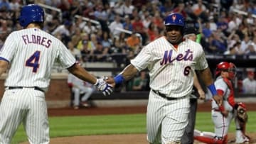 Aug 26, 2013; New York, NY, USA; New York Mets right fielder Marlon Byrd (6) is congratulated by third baseman Wilmer Flores (4) after scoring a run against the Philadelphia Phillies during the second inning of a game at Citi Field. Mandatory Credit: Brad Penner-USA TODAY Sports