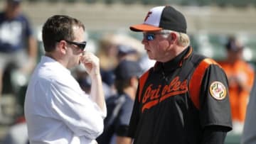 Mar 15, 2014; Sarasota, FL, USA; American columnist for ESPN Buster Onley talks with Baltimore Orioles manager Buck Showalter (26) prior to the game against the New York Yankees at Ed Smith Stadium. Mandatory Credit: Kim Klement-USA TODAY Sports