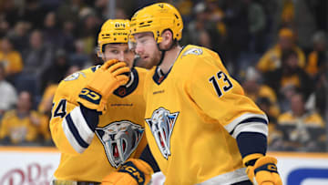 Nov 29, 2022; Nashville, Tennessee, USA; Nashville Predators left wing Tanner Jeannot (84) talks with center Yakov Trenin (13) before a face off during the second period against the Anaheim Ducks at Bridgestone Arena. Mandatory Credit: Christopher Hanewinckel-USA TODAY Sports