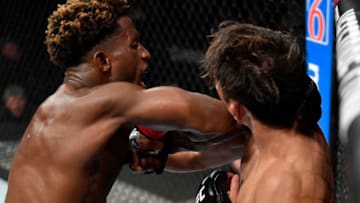 EDMONTON, ALBERTA - JULY 27: (L-R) Hakeem Dawodu of Canada elbows Yoshinori Horie of Japan in their featherweight bout during the UFC 240 event at Rogers Place on July 27, 2019 in Edmonton, Alberta, Canada. (Photo by Jeff Bottari/Zuffa LLC/Zuffa LLC)