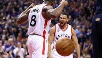 Apr 18, 2016; Toronto, Ontario, CAN; Toronto Raptors center Bismack Biyombo (8) celebrates with point guard Cory Joseph (6) after dunking the ball against the Indiana Pacers in game two of the first round of the 2016 NBA Playoffs at Air Canada Centre. The Raptors beat the Pacers 98-87. Mandatory Credit: Tom Szczerbowski-USA TODAY Sports
