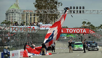 LONG BEACH, CA - APRIL 13: A coast guard's parachute gets stuck on the light structure for the standing start of the Verizon IndyCar Series Toyota Grand Prix of Long Beach on April 13, 2014 on the streets of Long Beach, California. (Photo by Jonathan Moore/Getty Images)