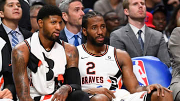 LOS ANGELES, CA - DECEMBER 03: Los Angeles Clippers Guard Paul George (13) and Los Angeles Clippers Forward Kawhi Leonard (2) look on from the bench during a NBA game between the Portland Trail Blazers and the Los Angeles Clippers on December 3, 2019 at STAPLES Center in Los Angeles, CA. (Photo by Brian Rothmuller/Icon Sportswire via Getty Images)