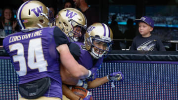 SEATTLE, WA - SEPTEMBER 09: Wide receiver Dante Pettis #8 of the Washington Huskies is congratulated by teammates after scoring on a 67-yard punt return against the Montana Grizzlies at Husky Stadium on September 9, 2017 in Seattle, Washington. (Photo by Otto Greule Jr/Getty Images)