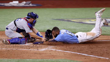 Manuel Margot #13 of the Tampa Bay Rays is tagged out by Austin Barnes #15 of the Los Angeles Dodgers on an attempt to steal home during the fourth inning in Game Five of the 2020 MLB World Series at Globe Life Field on October 25, 2020 in Arlington, Texas. (Photo by Tom Pennington/Getty Images)