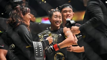 Singapore's Angela Lee (C) celebrates with family members after defeating Brazil's Istela Nunes during the Mixed Martial Art (MMA) One Womens Atomweight Championship on May 26, 2017 at the Indoor Stadium in Singapore. / AFP PHOTO / ROSLAN RAHMAN (Photo credit should read ROSLAN RAHMAN/AFP via Getty Images)