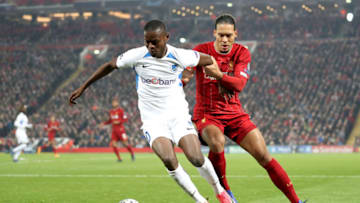 LIVERPOOL, ENGLAND - NOVEMBER 05: Ally Mbwana Samatta of KRC Genk is tackled by Virgil van Dijk of Liverpool during the UEFA Champions League group E match between Liverpool FC and KRC Genk at Anfield on November 05, 2019 in Liverpool, United Kingdom. (Photo by Alex Pantling/Getty Images)