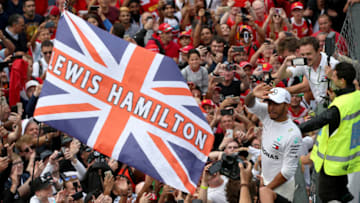 MONZA, ITALY - SEPTEMBER 02: Race winner Lewis Hamilton of Great Britain and Mercedes GP celebrates with fan after the Formula One Grand Prix of Italy at Autodromo di Monza on September 2, 2018 in Monza, Italy. (Photo by Charles Coates/Getty Images)